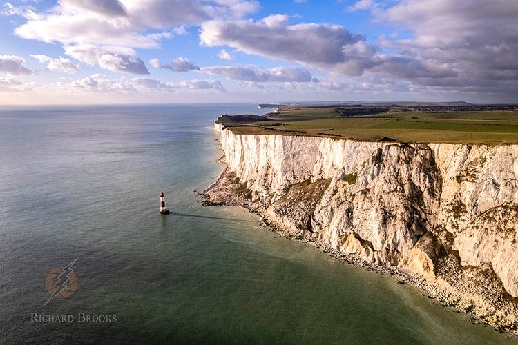 Aerial view of white cliffs and lighthouse