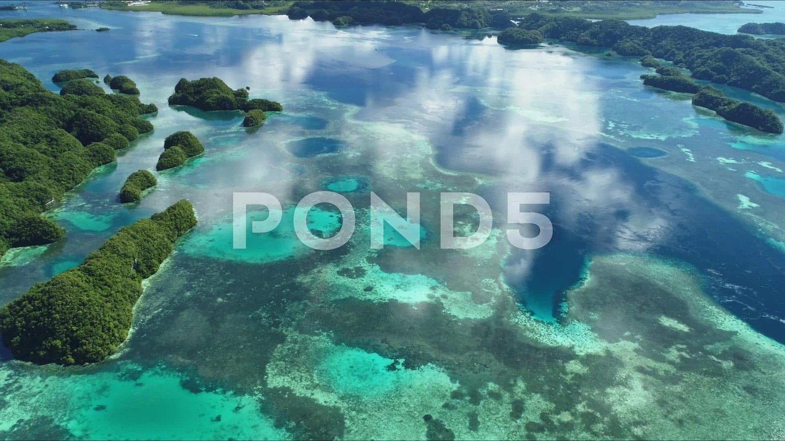 aerial stock footage shot of clouds reflected off tropical blue water